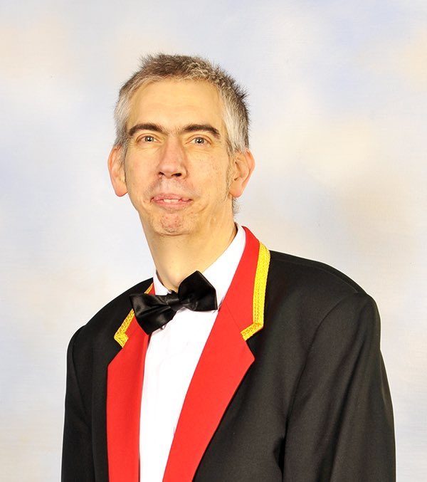 A portrait photograph of Chris Neufeld
