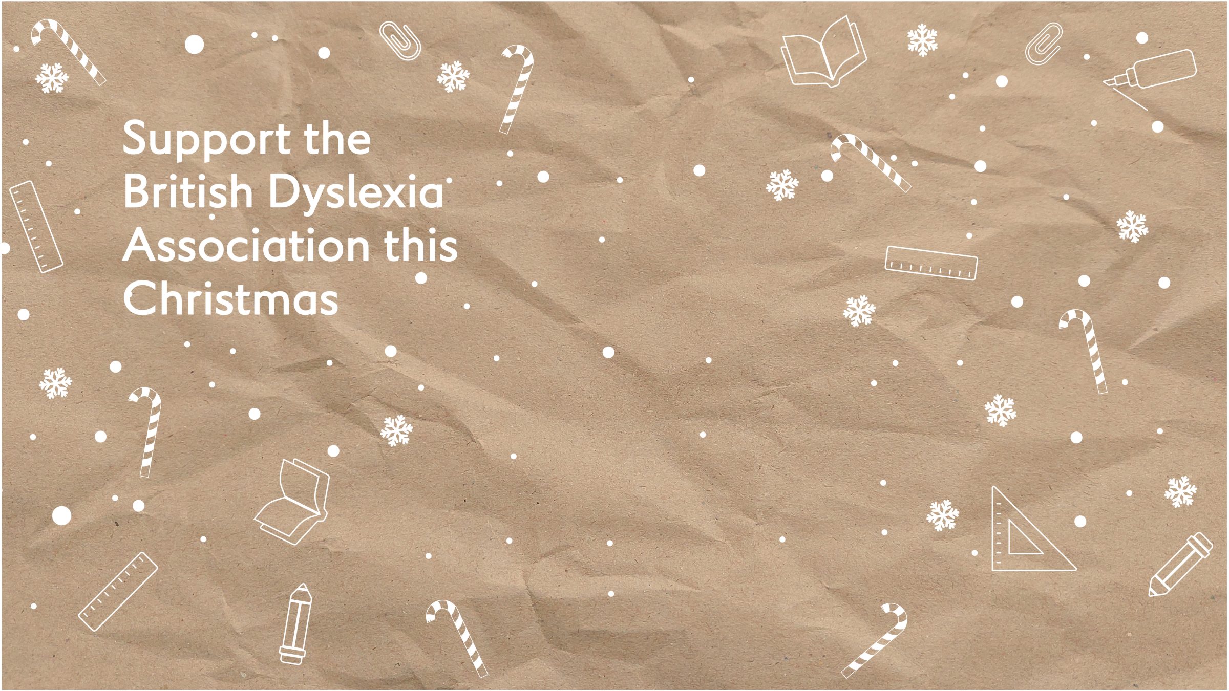 A Christmas tree in a snowy landscape, decorated with lights, colourful stars and a sparkly golden star on top.